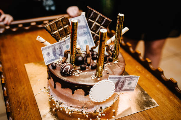 Festive Birthday Chocolate Cake Is Decorated With Gold Candles And Money.